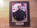 Picture: Mark Richt Georgia Bulldogs original 8 X 10 photo professionally double matted in team colors to 11 X 14 with a gold-plated plaque that reads "Mark Richt, Georgia Bulldogs." Have this custom framed in cherry wood or black and ready to hang on your wall for an additional $30.