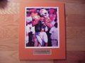 Picture: Peyton Manning Tennessee Volunteers original 8 X 10 photo professionally double matted in team colors to 11 X 14 to fit a standard frame with a gold plate that reads "Peyton Manning, #16, Tennessee Volunteers."