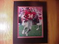 Picture: Herschel Walker Georgia Bulldogs 8 X 10 photo running for a touchdown against Tennessee from Georgia's 44-0 win over the Volunteers in 1981, the season opener and first game of the early 1980's Sanford Stadium expansion. The 8 X 10 photo has been professionally double matted in Georgia black on red to 11 X 14 to fit a standard frame.