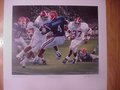 Picture: Daniel Moore hand-signed Alabama Crimson Tide "Rebirth in the Swamp" print features Shaun Alexander running through Florida in 1999 40-39 road overtime win.