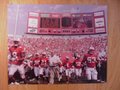 Picture: Barry Alvarez leads the Wisconsin Badgers onto the field at Camp Randall Stadium original 8 X 10 photo.