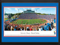 Picture: Kansas Jayhawks Memorial Stadium 13 X 40 panoramic print professionally double matted in team colors and framed to 18 X 44. This panorama, taken by James Blakeway, features Memorial Stadium - home to the Kansas Jayhawks football team. Kansas played its first game in Central Park in 1890. Two years later, they moved to McCook Field. In 1921 the Jayhawks moved again into Memorial Stadium, the first college campus stadium built west of the Mississippi River. It is the seventh-oldest college stadium in the nation with capacity at 50,071. It is dedicated to the University of Kansas students who fought and died in World War I. The Jayhawks have appeared in 11 bowl games and won or shared 6 conference titles in its history. Traditionally, fans chant "Rock Chalk, Jayhawk" during games. The University, founded in 1865 in Lawrence, Kansas, educates 29,613 students.