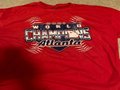 Picture: Atlanta City Celebration Shirt Medium Size made of High Quality Heavy Cotton! This shirt celebrates the 2021 Atlanta Braves as World Series Champions with the state of Georgia in the "o" spot in champions. Finally an affordable way to represent the Atlanta Braves as 2021 World Series Champions!