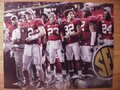 Picture: Alabama Crimson Tide 2009 SEC Champions image 12. We are the exclusive copyright holder of this image. Greg McElroy holds the 2009 SEC Championship Trophy with Nick Saban and other players in the background original 20 X 30 enlargement.