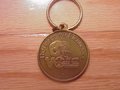 Picture: Tennessee Volunteers original key chain coin. This is 1 1/2 X 1 X 1 1/2 and five inches around. The school's 2003 schedule is on the back. We have just one!