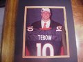 Picture: Tim Tebow Denver Broncos 8 X 10 photo professionally double matted in Bronco colors to 11 X 14 so that it fits a standard frame. If you want the photo matted in Florida Gators colors just let us know and we can do that too!