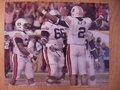 Picture: Cam Newton is about to hug is 323-pound offensive lineman Mike Berry Auburn Tigers original 16 X 20 SEC Championship photo/print. We are the exclusive copyright holders of this image.