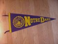 Picture: This is an original and vintage 1970's Notre Dame Fighting Irish Pennant. In very good shape with no pin holes or tears. This is a full size original pennant that measures 29 inches and has the old time tassels on it. Buyer pays 8.95 Priority Insured with Tracking Number Postage to have pennant sent flat well protected.
