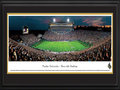 Picture: Purdue Boilermakers Ross-Ade Stadium 13.5 X 40 panoramic poster professionally double matted in team colors and framed to 18 X 44. This panorama of Ross-Ade Stadium, taken by Robert Pettit, captures the excitement of a Purdue Boilermakers' football game. Nestled on the northern edge of campus, Ross-Ade Stadium is named after principal benefactors David E. Ross and George Ade. Ross-Ade Stadium opened in the fall of 1924 with a seating capacity of 13,500. After multiple renovations, the current capacity is 62,500. From 2001 to 2003, Ross-Ade Stadium underwent a renovation that made it one of the most attractive and fan-friendly facilities in all of college football. Located on 150 acres in West Lafayette, Indiana, Purdue University was founded in 1869 by philanthropist and businessman John Purdue. Presently, enrollment tops 39,000 students.