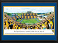 Picture: West Virginia Mountaineers Mountaineer Field at Milan Puskar Stadium 2012 Big 12 Debut panoramic poster of the team's record setting 70-63 win over Baylor professionally double matted in team colors and framed. The highest scoring game in Big 12 history and what a debut as Geno Smith throws for 656 yards and eight touchdowns! This panorama, taken by Christopher Gjevre, captures the West Virginia Mountaineers making their Big 12 debut against the Baylor Bears. Mountaineer fans marked the event with the first-ever "Stripe the Stadium" promotion and wore either gold or blue, based on where they were sitting in the stadium. In addition to the Mountaineers' success on the field, Homecoming festivities added to the jubilation in Morgantown. The first football homecoming celebrations date back to 1921, with the first Homecoming queen crowned in 1939. The West Virginia Mountaineers play football at Mountaineer Field at Milan Puskar Stadium, which opened in 1980 and seats 60,000 fans.