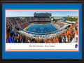 Picture: Boise State Broncos Bronco Stadium panoramic poster of the team's 2013 home opener, a 63-14 win over Tennessee-Martin in Chris Petersen's last year, professionally double matted in team colors and framed. This panorama of Bronco Stadium, taken by Christopher Gjevre, spotlights the Boise State Broncos football team playing their home opener against the University of Tennessee-Martin Skyhawks. This game also commemorates the opening of the Bleymaier Football Center, the Broncos new 70,000 square-foot athletic football complex in the north end zone. The Boise State players made their entrance onto the field through the new state-of-the-art complex, which houses a recruiting and players’ lounge, a weight room big enough for the entire team to work out and, of course, it has the infamous blue turf. Boise State fans added to the game day festivities by striping the stadium.