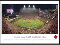 Picture: Arkansas Razorbacks Donald W. Reynolds Razorback Stadium panoramic poster professionally framed. This panorama of Donald W. Reynolds Razorback Stadium was taken by James Blakeway. The stadium opened in 1938 and was dedicated as Bailey Stadium. In 1941, it was renamed Razorback Stadium. The Reynolds name was added after a major contribution to the 2001 stadium renovation that increased capacity to 72,000. Today, the stadium boasts a new high definition video display to the north end zone, one of the biggest in college football. Arkansas also lays claim to the only Razorbacks in all of college athletics. Originally known as the Cardinals, the Razorbacks’ nickname resulted after a big win over LSU in 1909, when the Arkansas football coach called his players “a wild band of Razorback hogs.”