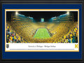 Picture: Michigan Wolverines Michigan Stadium 13.5 X 40 panoramic print professionally double matted in team colors and framed to 18 X 44. This panorama, taken by James Blakeway, captures a historical moment as the Michigan Wolverines played their first night game at the Big House on September 10, 2011. The event set a new Michigan Stadium and NCAA attendance record with a crowd of 114,804 fans. To further celebrate the occasion, the team wore ‘legacy' uniforms highlighting design elements from past eras, including a large ‘M' on the front of the jersey and numbers on the sides of the helmet. In the 39th meeting between the schools, Michigan defeated Notre Dame 35-31 with the final touchdown recorded in the last seconds of the game. Michigan now holds a 23-15-1 advantage in the classic rivalry.