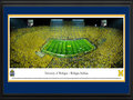 Picture: Michigan Wolverines Michigan Stadium 13.5 X 40 panoramic print professionally double matted in team colors and framed to 18 X 44. Considered among the most elite of college programs, this panorama memorializes the Michigan-Notre Dame football rivalry at its finest. The historic first game between the Michigan Wolverines and the Notre Dame Fighting Irish dates back to 1887, with the Wolverines winning the first eight contests. Fast forward 125+ years and, in front of a NCAA-record crowd of 115,109, the Wolverines once again were victorious with a final score of 41-30. This game, “Under the Lights II,” was only the second night game ever played at the Big House. Michigan currently ranks ahead of Notre Dame in both winning percentage and all time wins.