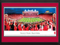 Picture: Nebraska Cornhuskers Memorial Stadium 13 X 40 panoramic print professionally double matted in team colors and framed to 18 X 44. This panorama, taken by Robert Pettit, captures the Nebraska Cornhuskers history-making evening as they hosted their first-ever Big Ten Conference home game at Memorial Stadium. The Huskers kept their poise and rallied for the biggest comeback in Nebraska football history for a win over the Ohio State Buckeyes with a final score of 34-27. Homecoming festivities added to the jubilation in Lincoln. Memorial Stadium has been sold out every game since November 3, 1962 and has recorded more wins than any other college football program since that date. In 2011, Nebraska switched conference membership from the Big 12 to the Big Ten Conference.