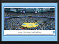 Picture: North Carolina Tar Heels Dean E. Smith Center 13 X 40 panoramic print professionally double matted in team colors and framed to 18 X 44. This panorama of the University of North Carolina men's basketball team, taken by Christopher Gjevre, captures the fan excitement after the Tar Heels make a slam dunk at the Dean E. Smith Center and ultimately defeat their opponent. The arena, commonly referred to as the Dean Dome, seats 21,750 fans and is named after former North Carolina coach Dean Smith, who coached the team from 1961 to 1997. The Tar Heels are one of the most successful programs in NCAA history and, on March 2, 2010, became the second college basketball program to reach 2,000 wins. They are one of only three Division I Men's Basketball programs to have ever achieved 2,000 victories.