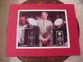 Picture: Tom Osbourne Nebraska Cornhuskers original 8 X 10 photo with the two consecutive National Championship trophies professionally double matted to 11 X 14 to fit a standard frame.