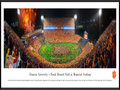 Picture: Just out from October 3, 2015 is a 13.5 X 40 panoramic poster of Frank Howard Field at Memorial Stadium professionally framed to 13.75 X 40.25. In this game the Clemson Tigers take an exciting 24-22 win over #6 ranked Notre Dame on ABC. This panorama of Frank Howard Field at Memorial Stadium, taken by James Blakeway, spotlights the excitement after a rain-soaked football match-up between two collegiate powerhouses, the Clemson University Tigers and Notre Dame. Despite the rain, Clemson fans packed Death Valley with orange ponchos and rain boots to cheer the Tigers to victory. The trademark Clemson colors are brilliantly on display, as Tiger fans "Gather at The Paw” following a big win.