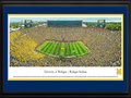 Picture: Just out as the Jim Harbaugh era begins for the Michigan Wolverines in Ann Arbor, Michigan with a 35-7 trouncing of Oregon State on September 12, 2015! Michigan Wolverines Michigan Stadium panoramic poster professionally double matted in team colors and framed to 18 X 44. This panorama, taken by James Blakeway, captures the University of Michigan Wolverines in their home opener against the Oregon State University Beavers. It marks the first home game for J. Ira and Nicki Harris Family Head Football Coach Jim Harbaugh. The game also kicks off a year-long celebration of Michigan Athletics' 150th Anniversary. The Michigan Wolverines intercollegiate competition officially began its rich and storied tradition in the season of 1865-66 and, since that time, the athletic teams have claimed many national championships, beginning with football’s 1901 national title.