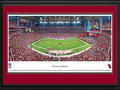 Picture: This 13.5 X 40 panorama has been professionally double matted in team colors and framed to 18 X 44. It features the Arizona Cardinals playing at University of Phoenix Stadium. After playing 18 years at Sun Devil Stadium, the Arizona Cardinals finally had a stadium to call their own when University of Phoenix Stadium opened with much fanfare in 2006. With its exterior skin representing the indigenous barrel cactus, it was the first stadium built in North America with both a retractable roof and a retractable field. The field weighs 18.9 million pounds and is moved in only for game days. The Cardinals are the oldest existing professional football club in the United States and are a charter member of the National Football League. From the NFL Stadiums collection.