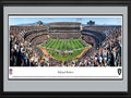 Picture: This 13.5 X 40 panoramic has been professionally double matted in team colors and framed to 18 X 44. It underscores the on-field action of the Oakland Raiders playing to their home crowd at Oakland-Alameda County Coliseum. The Raiders began play in 1960, as a charter member of the American Football League (AFL), and joined the National Football League (NFL) in 1970. In the ensuing five decades, the Raiders have won an AFL Championship; won four AFC Championships; participated in five Super Bowls, winning three Super Bowls; and won or tied for seventeen division titles. The Raiders are the only club in the NFL to play in at least one Super Bowl in the 1960s, 1970s, 1980s, and 2000s. From the NFL Stadiums collection.