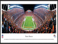 Picture: This panorama of the Denver Broncos playing at Invesco Field has been professionally framed to 13.75 X 40.25. The club reached the NFL's pinnacle by capturing its first World Championship in Super Bowl XXXII. Since 1960 the Denver Broncos have grown into a team that is followed by legions of fans throughout the Rocky Mountain region. The Broncos popularity has translated into several home game traditions, and one such tradition is called the "Incomplete Chant." It begins when the opposing team throws an incomplete pass, the stadium announcer then broadcasts the incomplete pass, the fans complete the chant by saying "in-com-plete," and the process ends with the sound effect of the "sad trombone." From the NFL Stadiums collection.