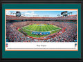 Picture: This 13.5 X 40 panorama of the Miami Dolphins playing to a capacity crowd at Sun Life Stadium has been professionally double matted in team colors and framed to 18 X 44. Originally known as Joe Robbie Stadium, Sun Life Stadium is a multi-purpose stadium in the South Florida suburb of Miami Gardens and the first of its kind in the NFL to be constructed entirely with private funds. The Dolphins began play in the American Football League (AFL) as an expansion team in 1966 and are the oldest major-league professional sports franchise in the state of Florida. In 1972, the Dolphins completed the NFL's first perfect season, culminating a 17-0 record with a win in Super Bowl VII. They were also the first team to appear in three consecutive Super Bowls. From the NFL Stadiums collection.