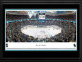 Picture: This 13.5 X 40 panorama of the San Jose Sharks at the Shark Tank has been professionally double matted in team colors and framed to 18 X 44. The Sharks joined the National Hockey League in 1991 and have become one of the league’s most successful franchises, on and off the ice. The team made history in 1994, compiling the largest single-season turnaround in NHL history, finishing with 82 points, a 58-point jump from the previous season. That year, they also earned their first Stanley Cup Playoff series victory when the No. 8 seeded Sharks defeated the Presidents’ Trophy-winning Detroit Red Wings, another NHL first. The Sharks are famous for their pre-game entrance to the ice when the players skate out through a 17-foot tall shark mouth with fog pouring out and eyes flashing red.