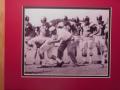 Picture: Bear Bryant runs an Alabama Crimson Tide practice original 8 X 10 photo professionally double matted to 11 X 14 so that it fits a standard frame.
