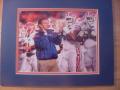 Picture: Urban Meyer and his Florida Gators players clap in unity 8 X 10 photo professionally double matted in team colors to 11 X 14 so that it fits a standard frame.