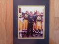 Picture: The classic. Bo Schembechler stands Michigan Proud as he is about to lead his Michigan Wolverines onto the field in Pasadena for the Rose Bowl. This original 8 X 10 photo is so good that you can clearly see the Rose Bowl patch on the players' uniforms. The photo has been professionally double matted to 11 X 14 so that it fits a standard frame you can buy anywhere.