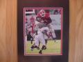 Picture: Georgia Bulldogs Knowshon Moreno original 8 X 10 glossy photo of "The Hurdle" against Central Michigan on September 6, 2008 professionally double matted to 11 X 14 so that it fits a standard frame. This is an actual game photo of Moreno's "Leap to Legend" over a nearly 6-foot Central Michigan safety and not a copy of a photo.