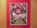 Picture: Heisman Trophy Winner Troy Smith in the pocket and ready to throw another completion for the Ohio State Buckeyes original 8 X 10 photo professionally double matted to 11 X 14 to fit a standard frame.  