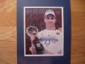 Picture: Peyton Manning holds the Super Bowl XLI Trophy for the Indianapolis Colts original 8 X 10 photo professionally double matted in team colors to 11 X 14 so that it fits a standard frame you can find easily and buy inexpensively. 