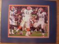 Picture: Brandon Spikes and other Florida Gators players during the 2009 BCS Championship Game 8 X 10 photo professionally double matted in team colors to 11 X 14 so that it fits a standard frame.