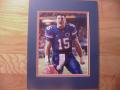 Picture: Tim Tebow of the Florida Gators rallies his team 8 X 10 photo professionally double matted in team colors to 11 X 14 so that it fits a standard frame.