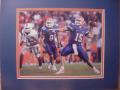 Picture: Tim Tebow of the Florida Gators takes apart the Miami 8 X 10 photo professionally double matted in team colors to 11 X 14 so that it fits a standard frame.