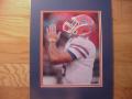 Picture: Tim Tebow of the Florida Gators prays to a higher power 8 X 10 photo professionally double matted in team colors to 11 X 14 so that it fits a standard frame. Here Tebow shows his commitment to teammates, fans, the game and a higher power above.